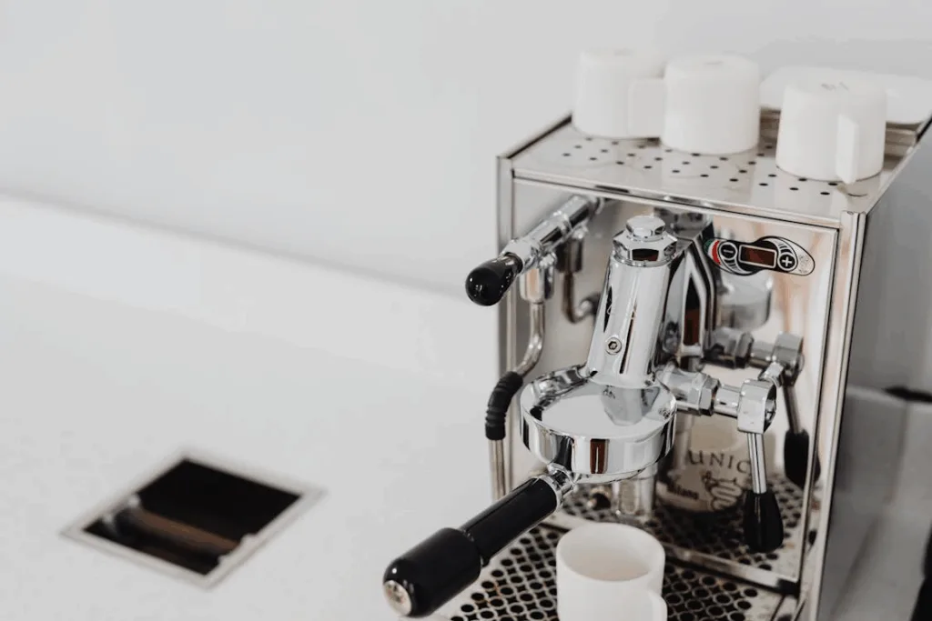 Home espresso station with grinder, tamper, and espresso machine.