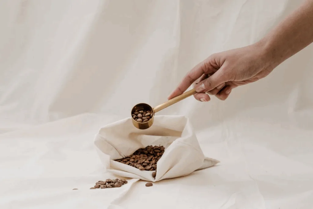 Organic Espresso Beans scooped from a white bag