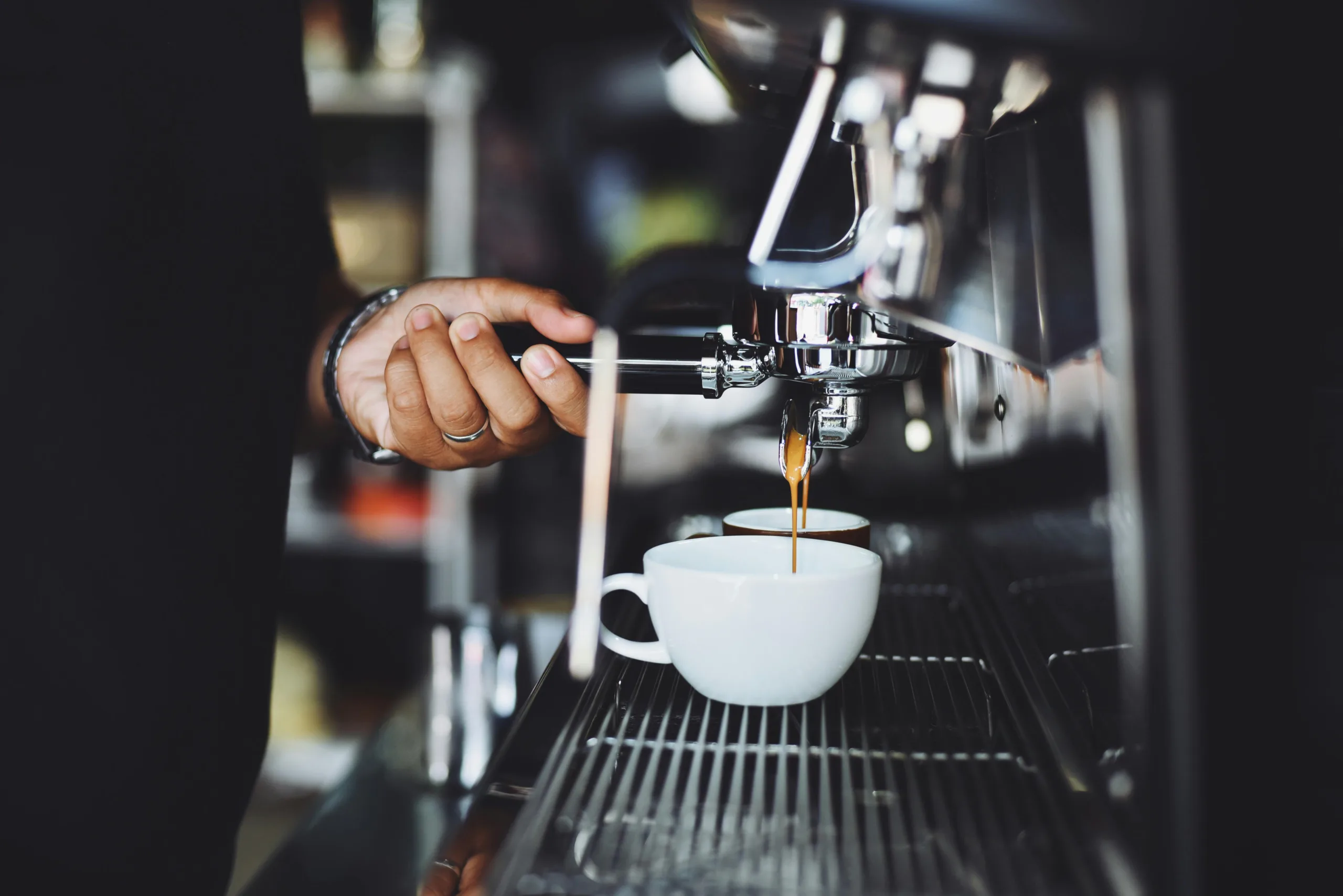 Espresso machine pulling a shot into a ceramic cup- best burr grinders ensure rich crema and balanced flavor