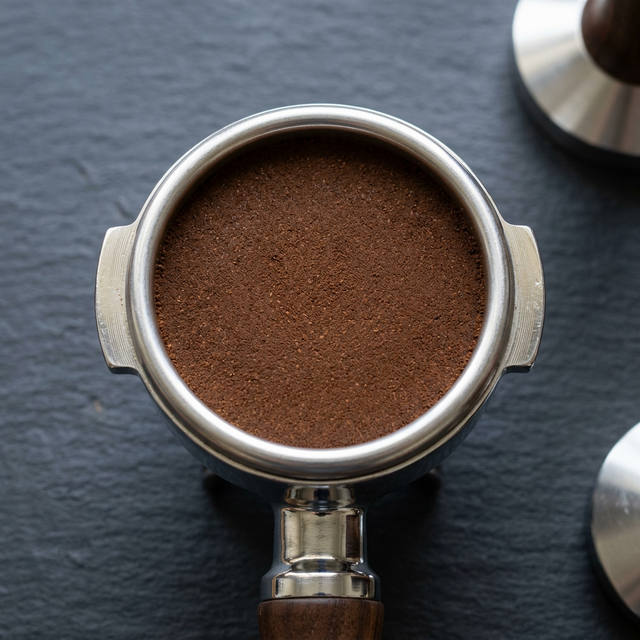 Perfectly distributed and tamped espresso puck ready for extraction