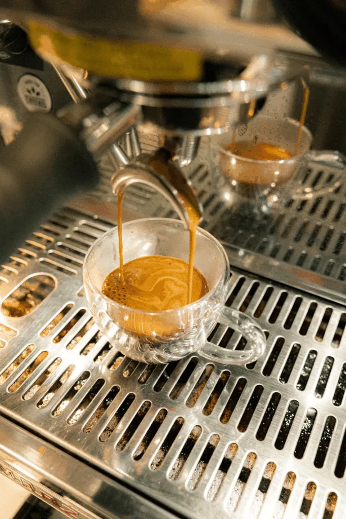 Perfect golden crema freshly brewed in a glass espresso cup