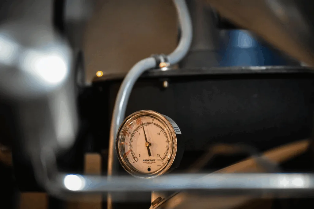 espresso machine on home counter with pressure gauge visible